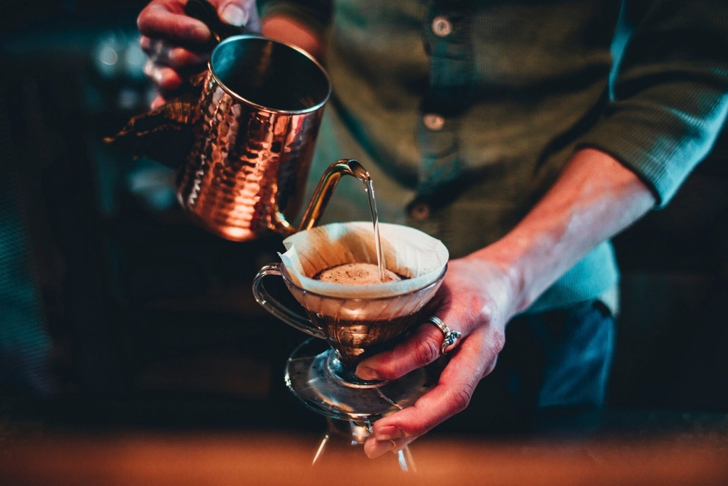 Barista pouring coffee at an event