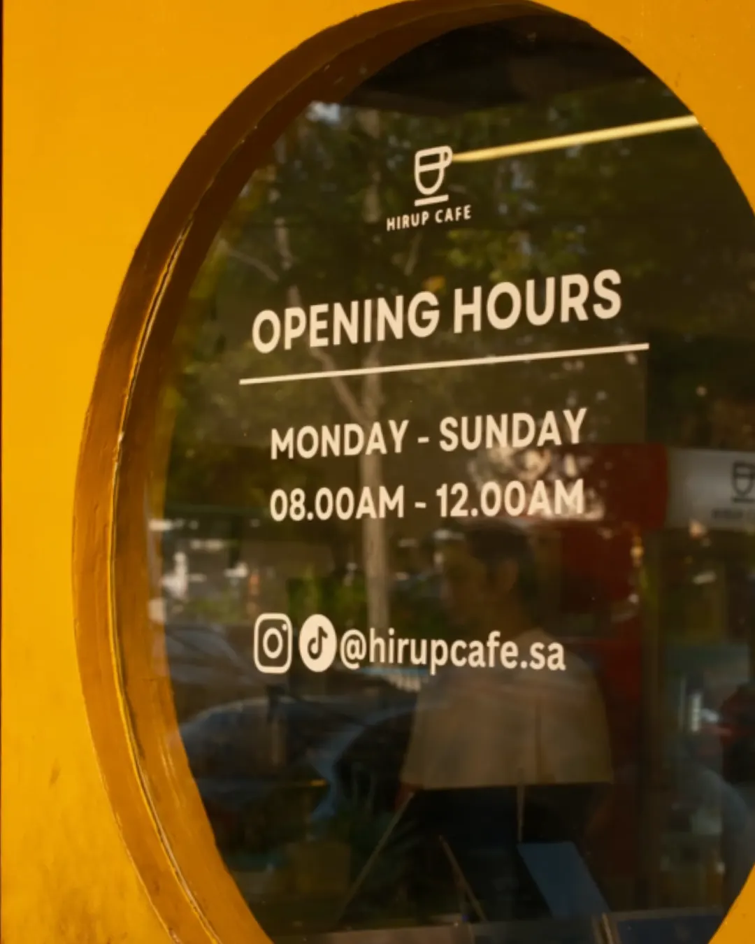 Hirup Cafe opening hours on the front window: Monday to Sunday, 8am to 12am